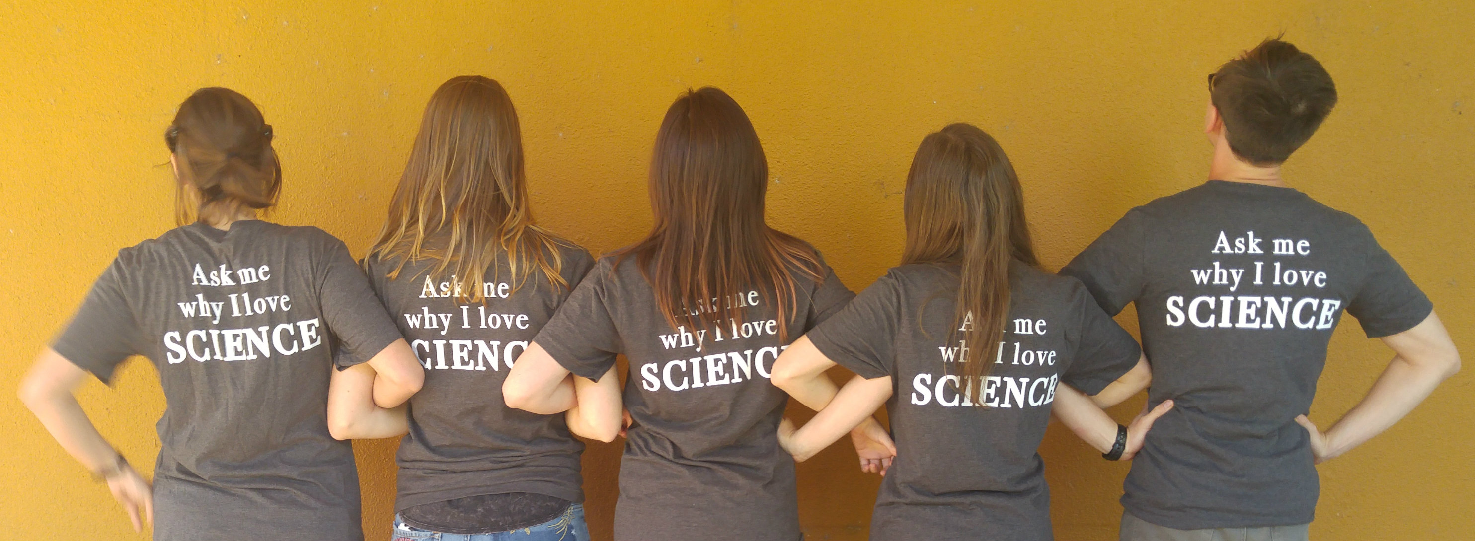 Five people wearing Science Says shirts that say "Ask me why I love Science"
